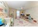Well-lit bedroom with bunk beds, desk, decorative wallpaper, and modern ceiling fan at 12664 Oak Hill Way, Parrish, FL 34219