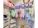 Organized closet with hanging clothes, shelves, and storage boxes at 12664 Oak Hill Way, Parrish, FL 34219