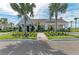 Beautifully landscaped clubhouse exterior featuring covered porch, manicured lawn, and inviting entryway at 12664 Oak Hill Way, Parrish, FL 34219
