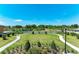 Serene community green space with walking paths, lush landscaping, and seating areas for relaxation and enjoyment at 12664 Oak Hill Way, Parrish, FL 34219