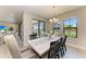 Dining room with a long table, seating for eight, and sliding glass doors to the backyard at 12664 Oak Hill Way, Parrish, FL 34219