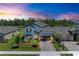 Stunning two-story home with a brick driveway, lush landscaping, and a two-car garage at 12664 Oak Hill Way, Parrish, FL 34219