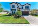 Beautiful two-story home featuring a brick driveway, manicured lawn, and a two-car garage at 12664 Oak Hill Way, Parrish, FL 34219