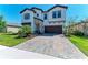 Beautiful two-story home featuring a brick driveway, manicured lawn, and a two-car garage at 12664 Oak Hill Way, Parrish, FL 34219