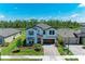 Stunning two-story home with a brick driveway, lush landscaping, and a two-car garage at 12664 Oak Hill Way, Parrish, FL 34219