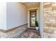 Inviting front entryway with brick floor, stone accent wall, and a decorative floral wreath on the glass front door at 12664 Oak Hill Way, Parrish, FL 34219