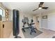 This home gym features a punching bag, weight bench, dumbbells, and ceiling fan at 12664 Oak Hill Way, Parrish, FL 34219