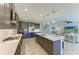 Open-concept kitchen with stainless steel appliances, a large island, and a seamless flow to the living area at 12664 Oak Hill Way, Parrish, FL 34219