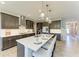Modern kitchen featuring dark cabinets, white countertops, stainless steel appliances, and a large island with bar seating at 12664 Oak Hill Way, Parrish, FL 34219