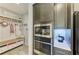 Built-in microwave and oven next to a hall tree with storage in a mudroom/entryway at 12664 Oak Hill Way, Parrish, FL 34219