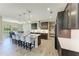 Modern kitchen with a large island, pendant lighting, dark cabinetry, and seating for four at 12664 Oak Hill Way, Parrish, FL 34219