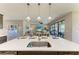 Kitchen island with seating and pendant lights, overlooking the living room and outdoor patio at 12664 Oak Hill Way, Parrish, FL 34219