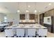 Beautiful kitchen with a center island, pendant lights, dark cabinetry, and an adjacent dining area at 12664 Oak Hill Way, Parrish, FL 34219