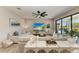 Bright living room with modern decor, a large TV, and sliding glass doors leading to an outdoor patio at 12664 Oak Hill Way, Parrish, FL 34219