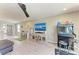 Spacious living room featuring hardwood floors, entertainment center and fun arcade games at 12664 Oak Hill Way, Parrish, FL 34219