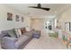 Bright living room features a large gray sectional couch and a modern ceiling fan at 12664 Oak Hill Way, Parrish, FL 34219