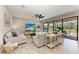 Cozy living room with stylish sofas, ceiling fan, sliding glass doors to the outdoor lanai, and neutral decor at 12664 Oak Hill Way, Parrish, FL 34219