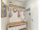 Mudroom with bench seating, storage, hooks, and a shelf with baskets and decor at 12664 Oak Hill Way, Parrish, FL 34219