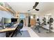 This office/gym features a desk with two monitors, punching bag, weight bench and other equipment at 12664 Oak Hill Way, Parrish, FL 34219