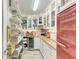 Well-organized pantry with ample shelving, wine cooler, and a red refrigerator for extra storage at 12664 Oak Hill Way, Parrish, FL 34219