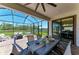 Beautiful screened patio with a dining area, outdoor furniture, and views of the waterfront at 12664 Oak Hill Way, Parrish, FL 34219