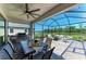 Beautiful screened patio with an outdoor kitchen, grill, dining area, and lovely view of a pond at 12664 Oak Hill Way, Parrish, FL 34219