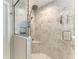 Modern glass enclosed shower features marble tile and rainfall showerhead at 12664 Oak Hill Way, Parrish, FL 34219