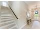 Open stairway with contemporary decor, leading to the upper level of the home at 12664 Oak Hill Way, Parrish, FL 34219