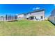 Spacious backyard with lush lawn, white fence, and trampoline, offering ample room for recreation at 12738 Hysmith Loop, Parrish, FL 34219