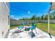 Backyard with patio and fire pit, featuring chairs, pavers, string lights, and vinyl privacy fence at 12738 Hysmith Loop, Parrish, FL 34219