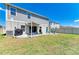 Open backyard with a patio, a grill, and plenty of space, perfect for barbecues and outdoor entertaining at 12738 Hysmith Loop, Parrish, FL 34219