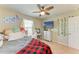 Bedroom with a ceiling fan, a mounted TV, and a vanity for getting ready in the morning at 12738 Hysmith Loop, Parrish, FL 34219