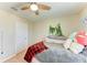 Bedroom with a cozy bed, ceiling fan, and decorative plants at 12738 Hysmith Loop, Parrish, FL 34219