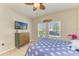 Bright bedroom with a dresser, TV, ceiling fan and two windows that let in ample natural light at 12738 Hysmith Loop, Parrish, FL 34219