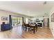 Open-concept dining area with hardwood floors, dining table, and access to the kitchen at 12738 Hysmith Loop, Parrish, FL 34219