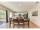 Open-concept dining area with hardwood floors, dining table, and access to the kitchen at 12738 Hysmith Loop, Parrish, FL 34219