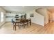 Open-concept dining area with hardwood floors, dining table, and access to the kitchen at 12738 Hysmith Loop, Parrish, FL 34219