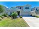 Two-story home featuring a concrete driveway, well-kept lawn, and a two-car garage at 12738 Hysmith Loop, Parrish, FL 34219