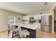 Kitchen island with pendant lighting, stainless steel appliances, and tile backsplash at 12738 Hysmith Loop, Parrish, FL 34219