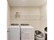 Laundry room with a washer and dryer, overhead shelf, and cat litter box next to the machines at 12738 Hysmith Loop, Parrish, FL 34219
