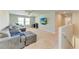 Upstairs living room features a sectional sofa and a mounted television at 12738 Hysmith Loop, Parrish, FL 34219