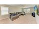 Upstairs living area with sectional sofa, carpet floors, and multiple windows at 12738 Hysmith Loop, Parrish, FL 34219