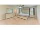 Spacious main bedroom with neutral tones, ceiling fan, and ensuite bathroom entrance at 12738 Hysmith Loop, Parrish, FL 34219