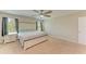 Bright main bedroom featuring a large window, ceiling fan and neutral tones at 12738 Hysmith Loop, Parrish, FL 34219