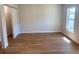 A bright bedroom features wood-look flooring and a large window for plenty of natural light at 1428 19Th St, Sarasota, FL 34234
