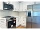 Modern kitchen featuring stainless steel appliances and white cabinets at 1428 19Th St, Sarasota, FL 34234