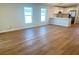 Open concept living area with hardwood flooring, white walls, and modern kitchen at 1428 19Th St, Sarasota, FL 34234
