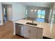Open-concept living room and kitchen with laminate flooring and lots of natural light at 1428 19Th St, Sarasota, FL 34234