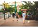Inviting street scene featuring people walking a dog on a sunny day at 1428 19Th St, Sarasota, FL 34234