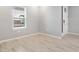 Bright, neutral bedroom with white trim and a view of the front yard at 1596 Laurel Brook Ln, Port Charlotte, FL 33953